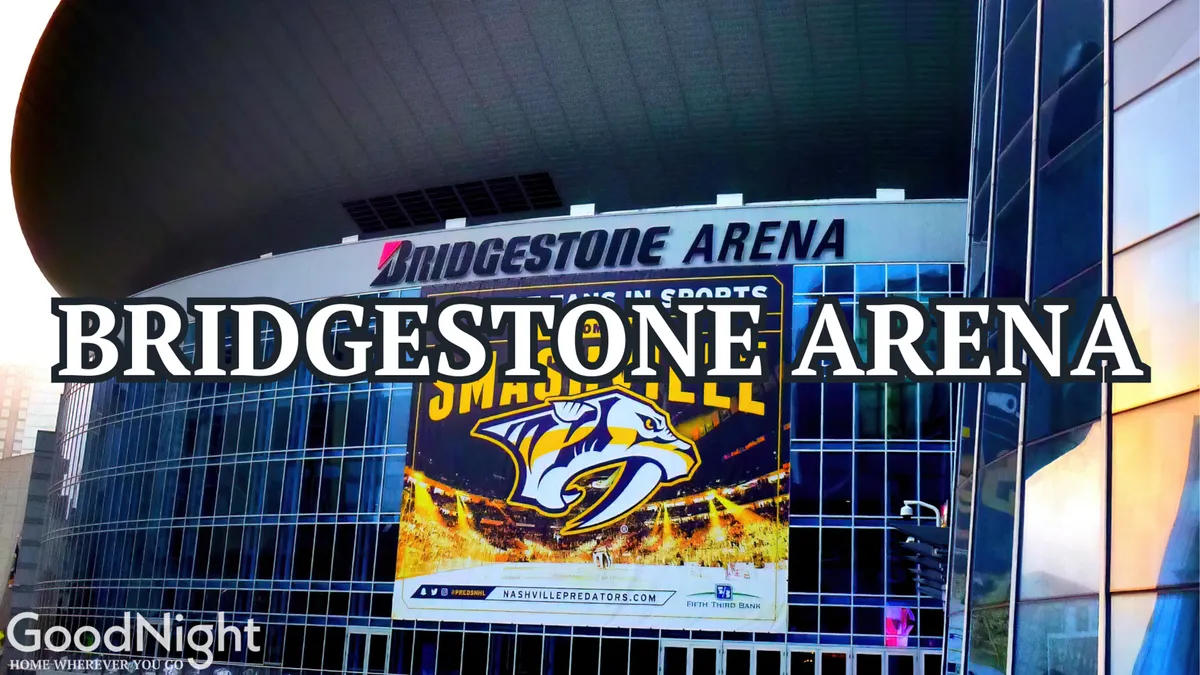 The recognizable exterior of Bridgestone Arena, featuring its signature sign and the Nashville Predators logo. The arena is surrounded by banners and the anticipation of events, suggesting a hotspot for concerts and major music events.