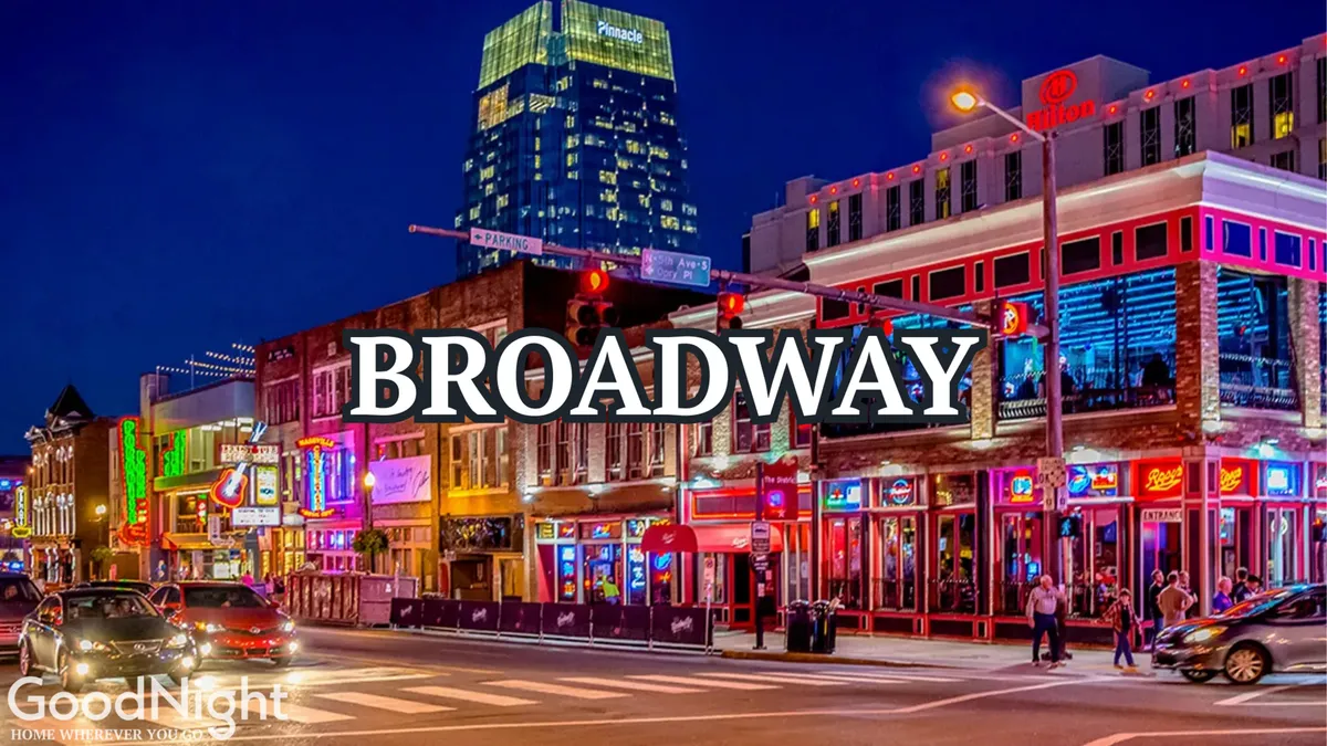 A vibrant Nashville street scene illuminated by neon signs, with people strolling along the sidewalks and lively buildings in the background. The atmosphere is energetic and bustling, evoking the heart of the city's nightlife district.